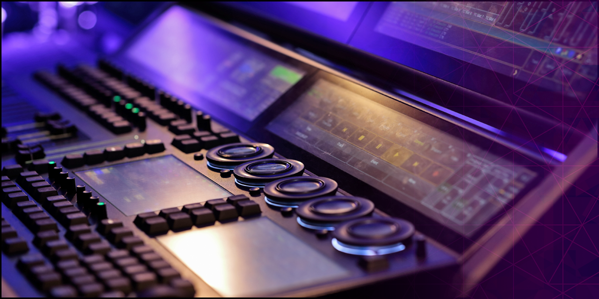 A close-up of a modern mixing console with illuminated buttons and digital displays in a music studio, bathed in purple and blue lighting.